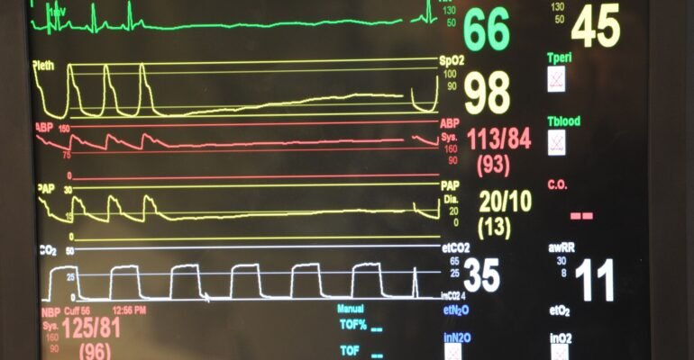 A vital-signs monitor displaying physiological waveforms such as ECG, illustrating biomedical signal analysis.