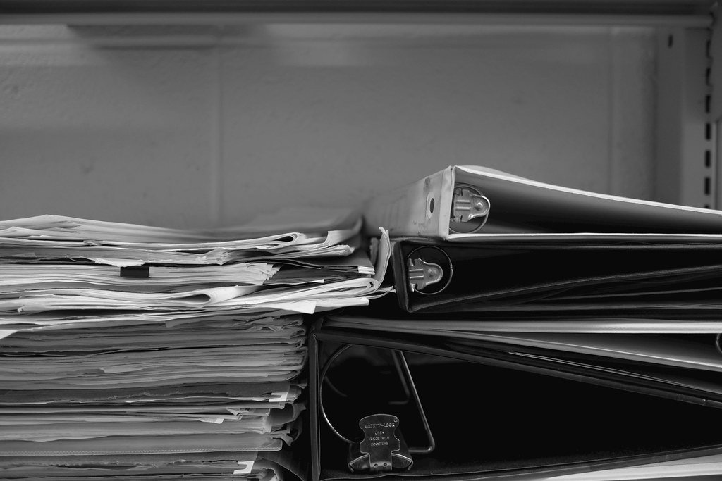 Regulatory documents and a binder, representing regulatory affairs and medical device regulation.