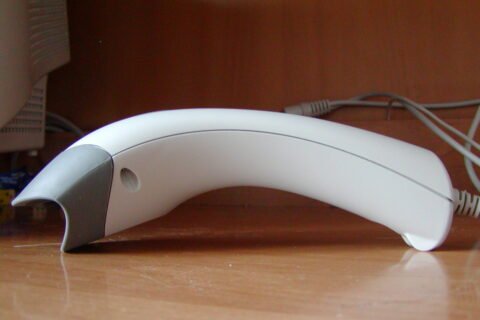 A handheld barcode scanner reading a product code, illustrating Unique Device Identification (UDI) on medical device labels.