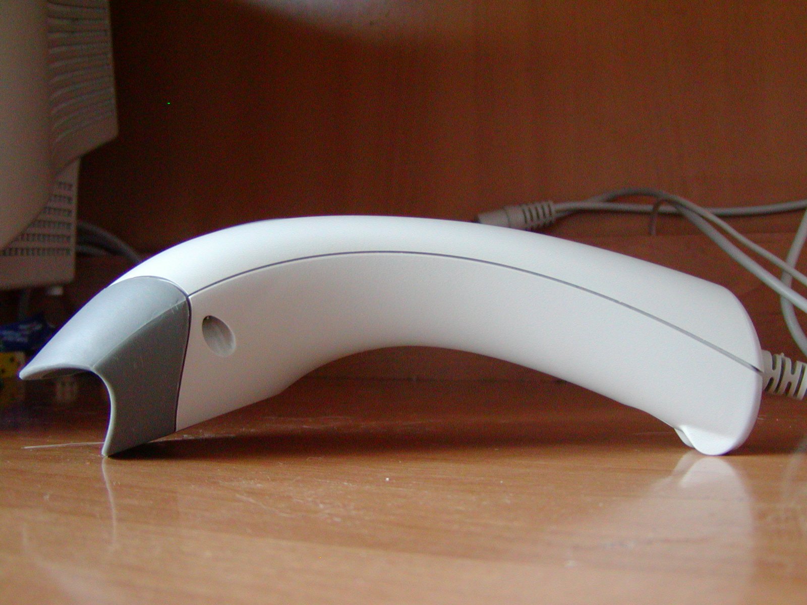 A handheld barcode scanner reading a product code, illustrating Unique Device Identification (UDI) on medical device labels.