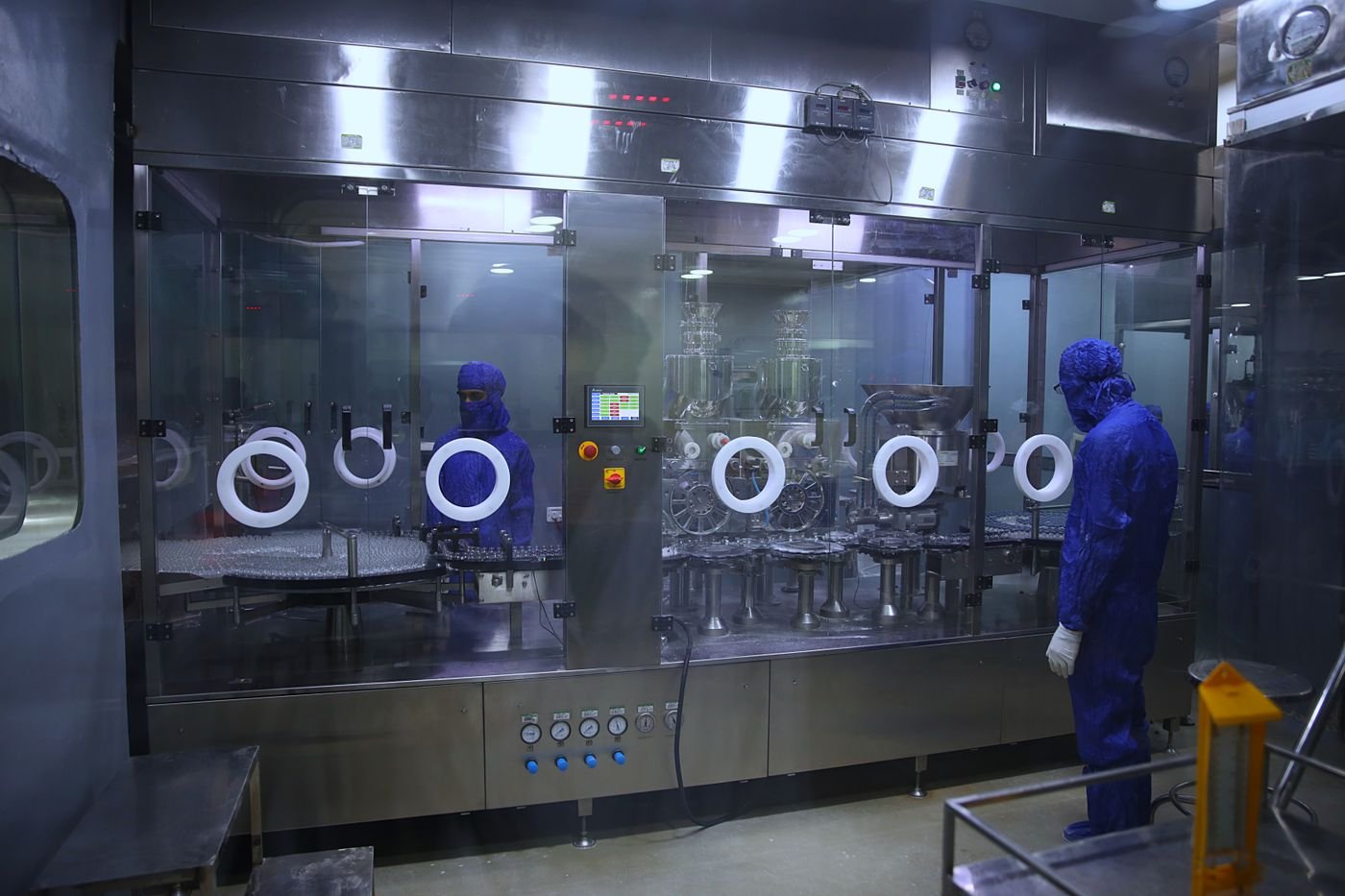 Workers in protective gear in a manufacturing cleanroom
