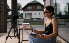 Professional taking notes during an online course on a laptop