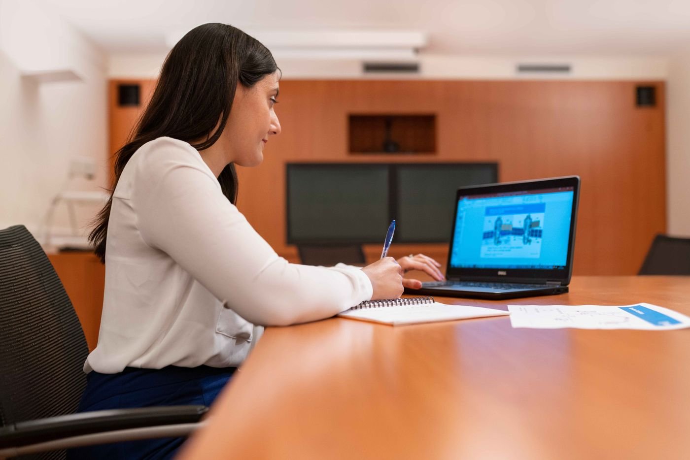 Professional working on a laptop in a modern setting