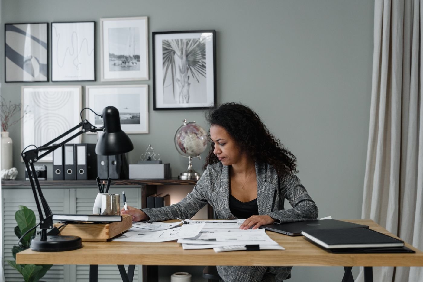 Professional evaluating documents at a modern desk