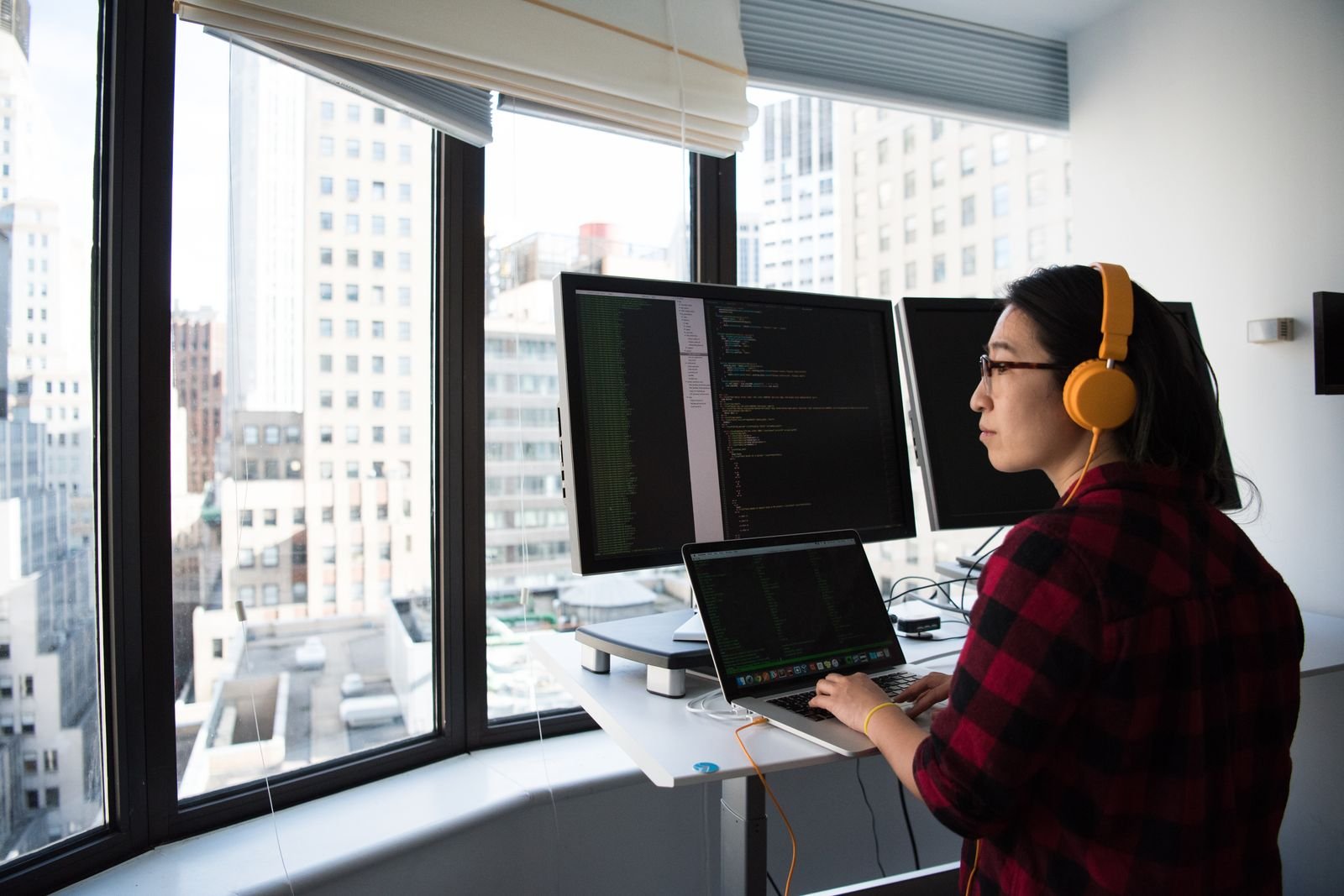Professional working at a multi monitor workstation