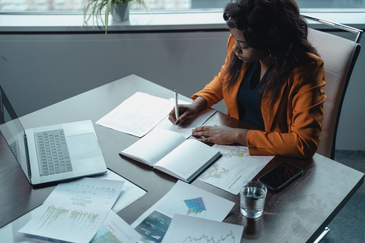 Writing regulatory documents with laptop in an office