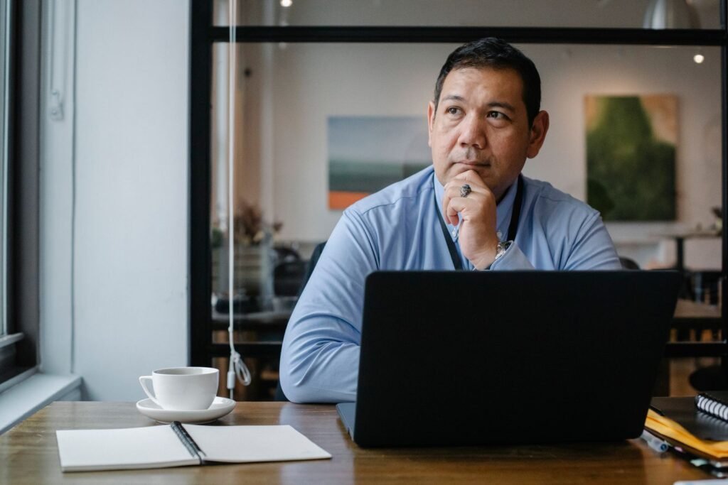 Professional reflecting and taking notes at a desk