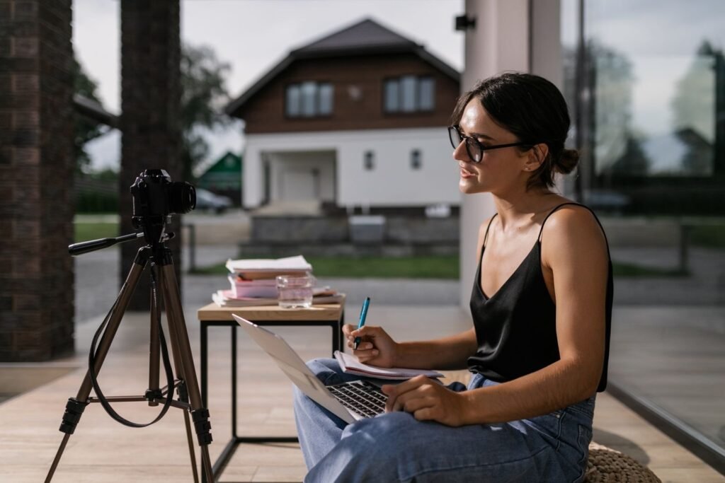 Professional taking notes during an online course on a laptop