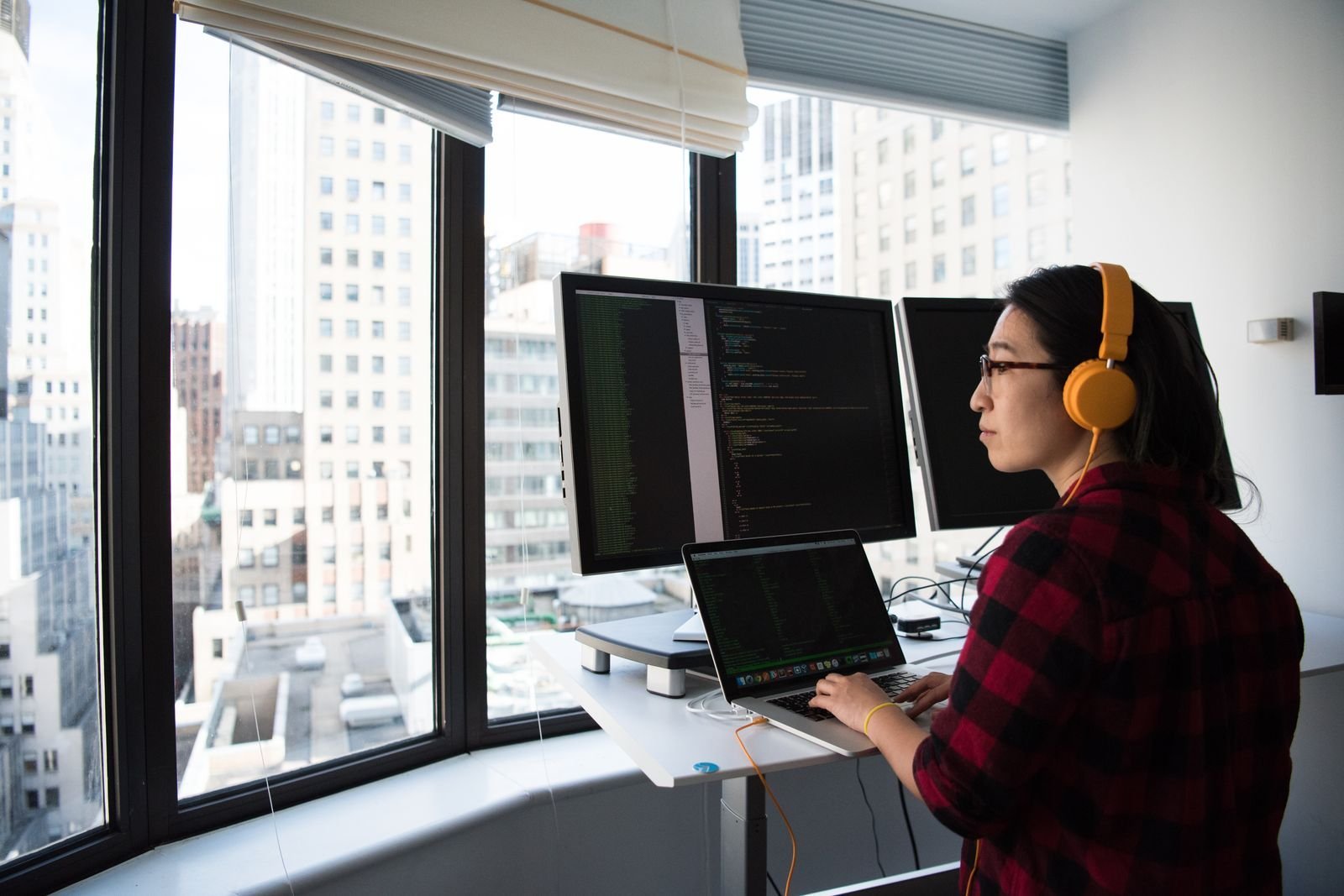 Professional working at a multi monitor workstation